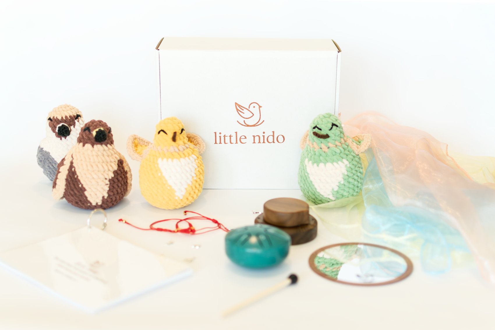 The Little Nido Foundation Kit — crochet birds, mini drum, wooden timer, mirror, scarf and bilingual guide